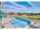 Sparkling pool with screened enclosure offers a picturesque view of the serene pond and surrounding community at 631 Reserve Dr, Davenport, FL 33896