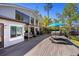 Expansive back deck with lounge area, umbrella, and hot tub perfect for outdoor enjoyment and lake views at 7841 Georgeann St, Winter Park, FL 32792