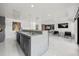 Home bar with full sink, bar refrigerator, concrete counter and easy access to living space at 7841 Georgeann St, Winter Park, FL 32792