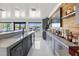 Long wet bar with sink, gray cabinets, and sliding door access to waterfront at 7841 Georgeann St, Winter Park, FL 32792