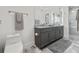 Elegant bathroom with double sink vanity and walk-in shower with marble tiling at 7841 Georgeann St, Winter Park, FL 32792