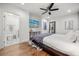 Bright bedroom featuring hardwood floors, a ceiling fan, and an ensuite bathroom at 7841 Georgeann St, Winter Park, FL 32792