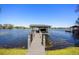 Waterfront view of boat dock and lift on a sunny day with blue skies at 7841 Georgeann St, Winter Park, FL 32792