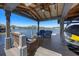 Covered boat house with lift featuring patio furniture and water view on a sunny day at 7841 Georgeann St, Winter Park, FL 32792