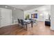 Bright dining room area with modern table, hardwood floors, and an adjacent living room at 7841 Georgeann St, Winter Park, FL 32792