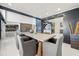 Dining area is open to the bar, kitchen, and living room with a decor that is contemporary and well-lit at 7841 Georgeann St, Winter Park, FL 32792