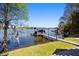 Picturesque dock featuring boat lifts and a covered area for relaxing by the tranquil lake at 7841 Georgeann St, Winter Park, FL 32792