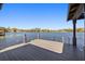 New dock on clear lake features a light gray wood-style finish and a stainless steel ladder at 7841 Georgeann St, Winter Park, FL 32792