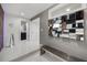 Modern entryway with white tiled floors, bench, and unique mirrored wall decor at 7841 Georgeann St, Winter Park, FL 32792