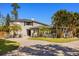 Beautiful home featuring lush tropical landscaping and a stone driveway at 7841 Georgeann St, Winter Park, FL 32792