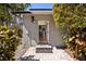 Charming home exterior featuring a tiled walkway leading to the front door and lush landscaping at 7841 Georgeann St, Winter Park, FL 32792