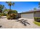 Exterior view of home featuring a two car garage, brick driveway, tropical landscaping and manicured lawn at 7841 Georgeann St, Winter Park, FL 32792