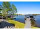 Scenic lake view featuring a covered dock and lush greenery from the home's relaxing outdoor space at 7841 Georgeann St, Winter Park, FL 32792