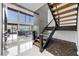 Modern living room featuring open staircase, large windows, and lake views at 7841 Georgeann St, Winter Park, FL 32792