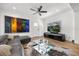Stylish living room with hardwood floors, a modern ceiling fan, and lots of space at 7841 Georgeann St, Winter Park, FL 32792