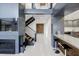 Modern living room features a fireplace, open staircase, and breakfast bar with white tile flooring at 7841 Georgeann St, Winter Park, FL 32792