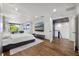 Main bedroom with king size bed, wood floors, lake views and a television at 7841 Georgeann St, Winter Park, FL 32792