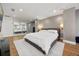 Lake house main bedroom featuring neutral walls, wood floors, king bed and layered mirrors at 7841 Georgeann St, Winter Park, FL 32792