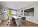 Home office with modern desk and chairs, wood floor, and lovely lake views at 7841 Georgeann St, Winter Park, FL 32792