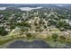 Wide aerial view of a home in a serene neighborhood near a lake at 809 Poinsettia Dr, Eustis, FL 32726