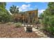 Backyard view of a home featuring a fire pit, inviting seating area, and mature landscaping at 809 Poinsettia Dr, Eustis, FL 32726