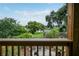 Backyard view from the wooden porch, featuring a manicured lawn and mature trees at 809 Poinsettia Dr, Eustis, FL 32726