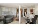 Functional basement area featuring tile flooring, a cozy chair, and a work desk at 809 Poinsettia Dr, Eustis, FL 32726