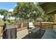 Inviting deck area, featuring comfortable outdoor seating, a grill, and serene backyard views at 809 Poinsettia Dr, Eustis, FL 32726