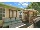 Relaxing outdoor deck with comfortable seating, a grill, and views of the surrounding greenery at 809 Poinsettia Dr, Eustis, FL 32726