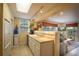 Cozy kitchen featuring a skylight, open layout, and bar counter, blending seamlessly with the living area at 809 Poinsettia Dr, Eustis, FL 32726