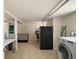 Basement laundry area, featuring tile flooring, a washer, and ample storage at 809 Poinsettia Dr, Eustis, FL 32726