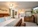 Main bedroom featuring a decorative ceiling fan, a TV, a mirror, and access to an ensuite bathroom at 809 Poinsettia Dr, Eustis, FL 32726