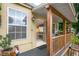 Charming porch featuring a blue bench and easy access to the bright and inviting living room at 809 Poinsettia Dr, Eustis, FL 32726