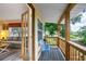 Inviting covered porch featuring a blue bench and a view into the cozy living room at 809 Poinsettia Dr, Eustis, FL 32726