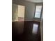 This bedroom is empty, has hardwood floors, and a gray paint color at 860 N Orange Ave # 149, Orlando, FL 32801