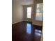 This bedroom is empty, has hardwood floors, and two windows for natural light at 860 N Orange Ave # 149, Orlando, FL 32801
