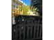 Charming building exterior with white picket fence, tropical landscaping, and architecture that creates a welcoming curb appeal at 860 N Orange Ave # 149, Orlando, FL 32801