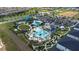 Community aerial view of a clubhouse, pool area, waterslide, miniature golf and playground at 9123 Sommerset Hills Dr, Davenport, FL 33896