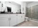 Bathroom featuring double vanity with gray countertops, glass-enclosed shower, and gray floor tile at 9123 Sommerset Hills Dr, Davenport, FL 33896