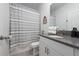 Bright bathroom featuring a shower, vanity, mirror and clean white towels at 9123 Sommerset Hills Dr, Davenport, FL 33896