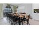 Elegant dining room with a long wooden table set for a meal and natural light from sliding glass doors at 9123 Sommerset Hills Dr, Davenport, FL 33896