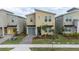 Contemporary home showcasing a stylish facade, neat landscaping, and a paved driveway at 9123 Sommerset Hills Dr, Davenport, FL 33896