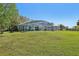 Sprawling backyard featuring a large screened patio enclosure, perfect for outdoor entertaining and relaxation at 1120 Parker Canal Ct, Oviedo, FL 32765