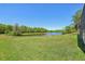 Large backyard with view of a lake at 1120 Parker Canal Ct, Oviedo, FL 32765