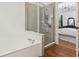 Bathroom featuring a soaking tub and separate glass shower with views into the bedroom at 1120 Parker Canal Ct, Oviedo, FL 32765