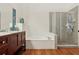 Bathroom featuring a double vanity, soaking tub, and separate glass shower at 1120 Parker Canal Ct, Oviedo, FL 32765
