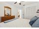 This bedroom features a ceiling fan, closet, dresser, mirror and blue decor at 1120 Parker Canal Ct, Oviedo, FL 32765
