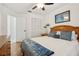 This bedroom features a ceiling fan, closet, painting, and a bed with blue decor at 1120 Parker Canal Ct, Oviedo, FL 32765