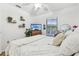 This bedroom features a ceiling fan, window, comfy bed, tv, and warm color scheme at 1120 Parker Canal Ct, Oviedo, FL 32765