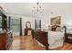Bedroom boasts hardwood floors, a chandelier, and decoratively furnished interior at 1120 Parker Canal Ct, Oviedo, FL 32765